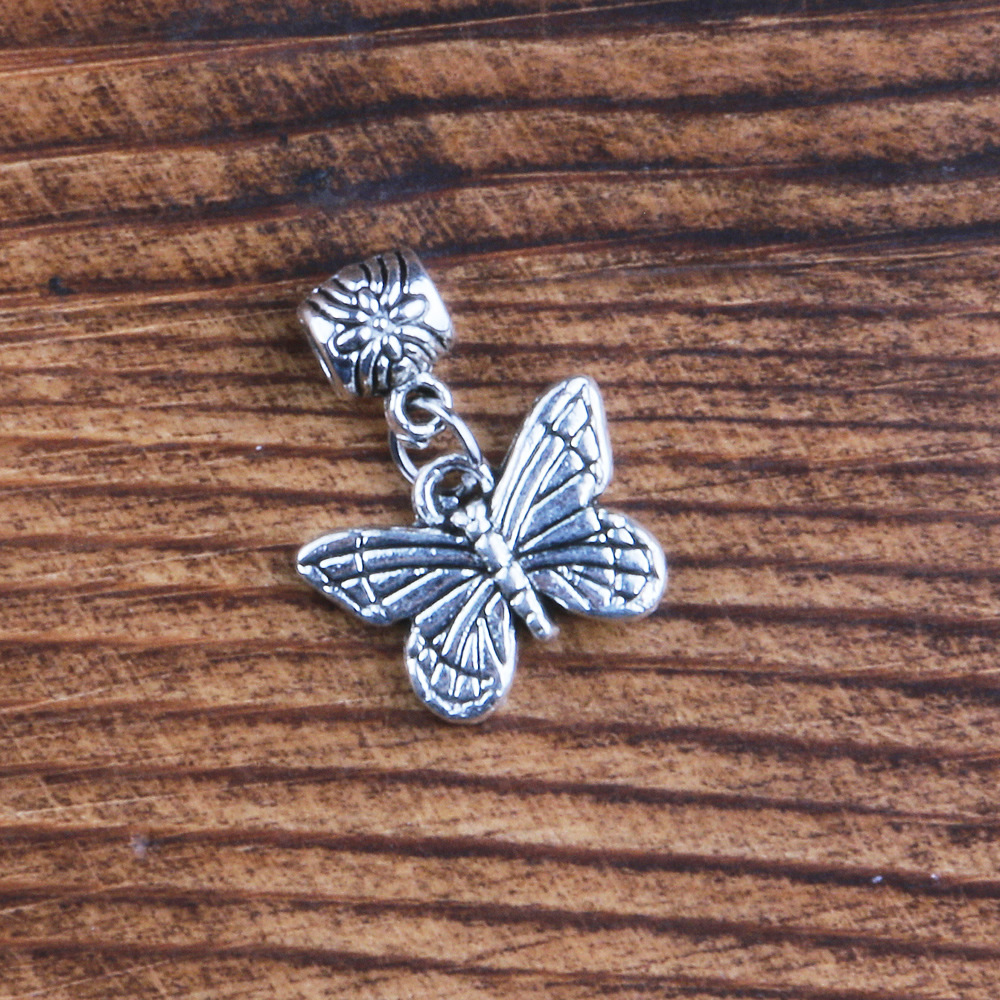A butterfly pendant with a ring