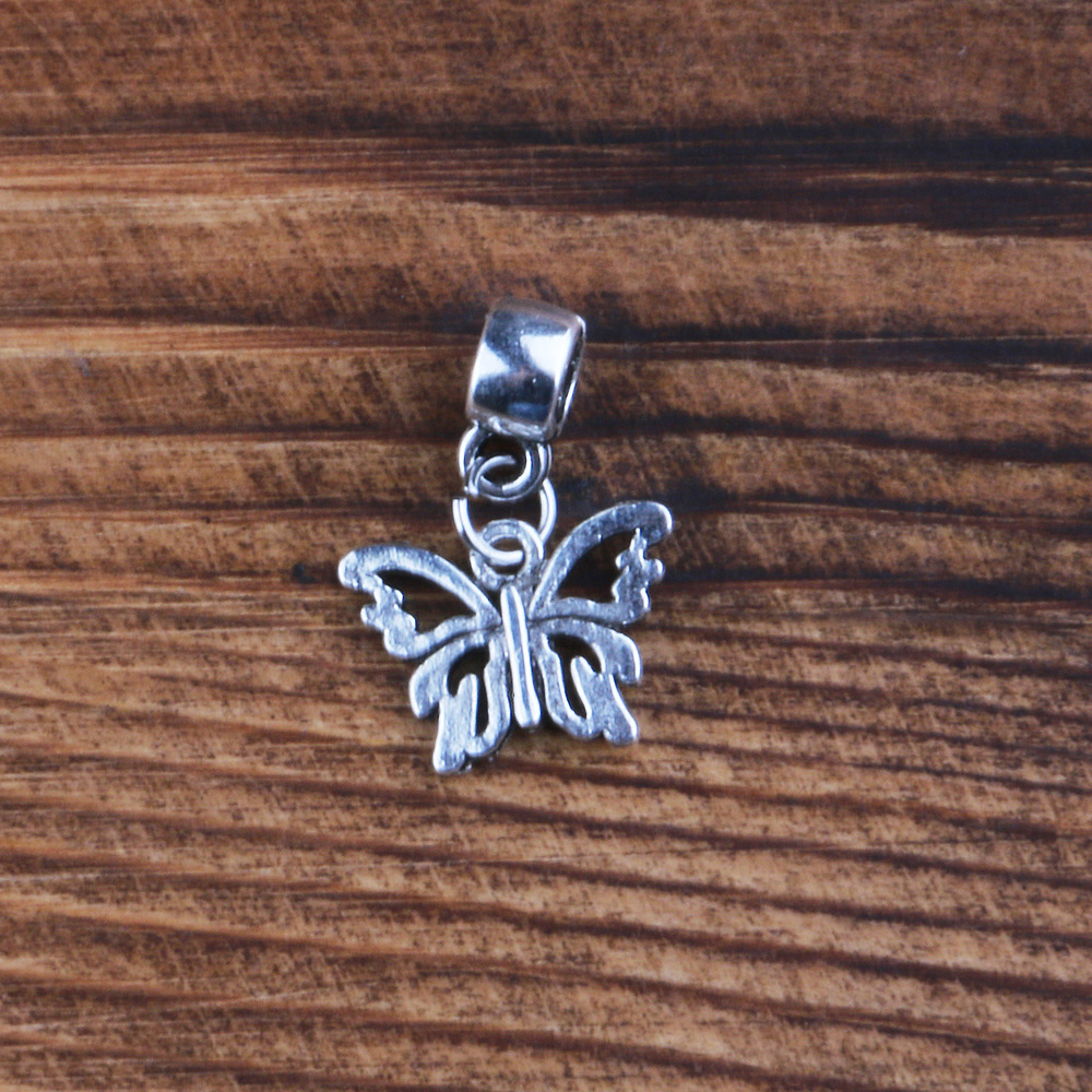 A butterfly pendant with a ring