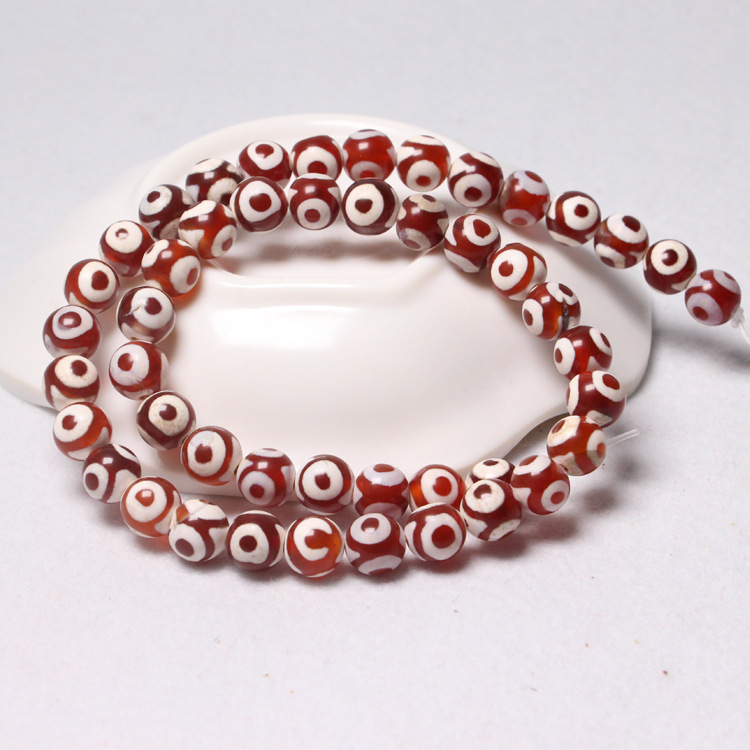 Red and white three-eyed beads