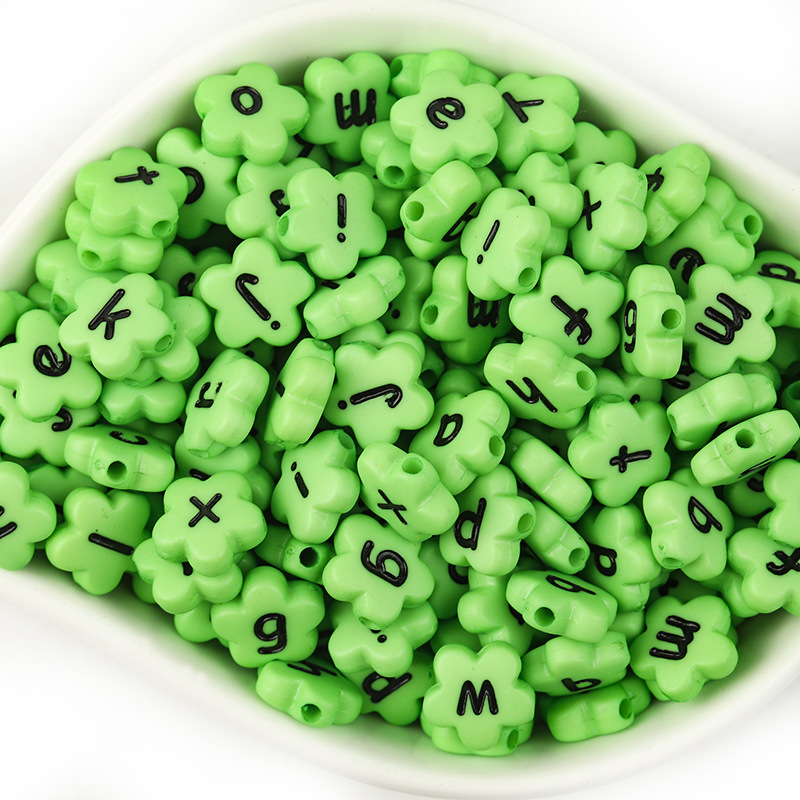 A pack of 100 green with black lowercase letters
