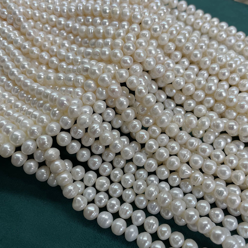 White thread beads, about 57 beads/strand