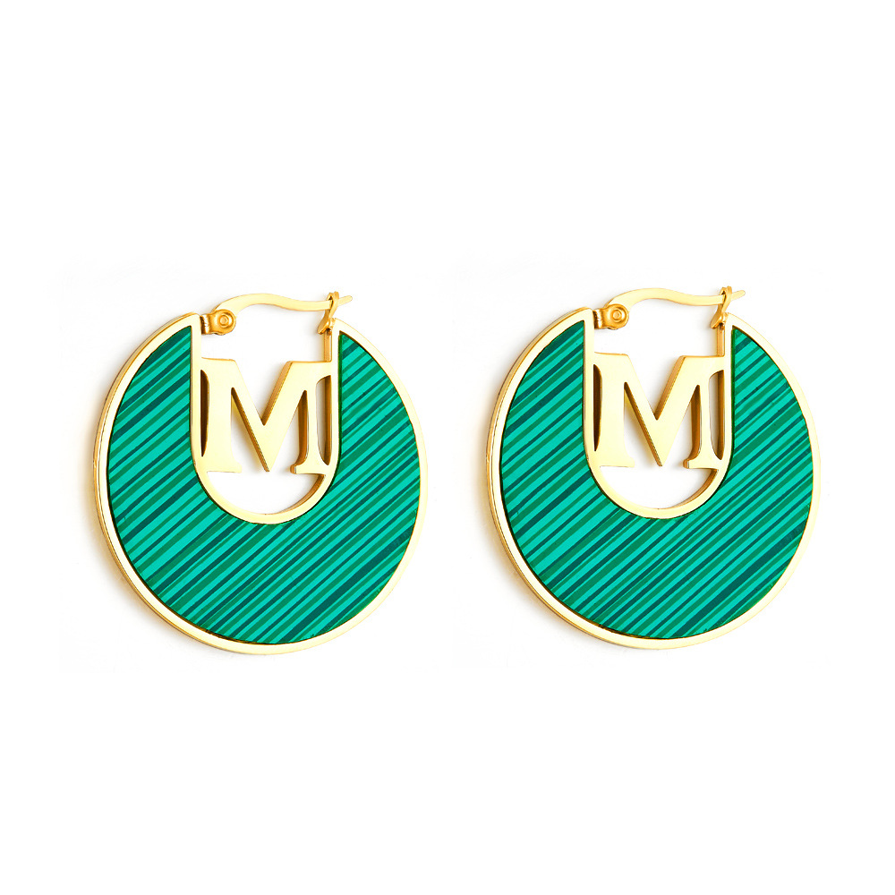 Green M letters gold