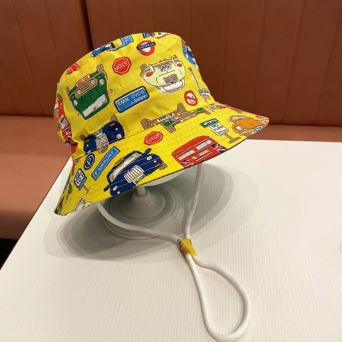 Bright yellow small brim cloth style multiple cars