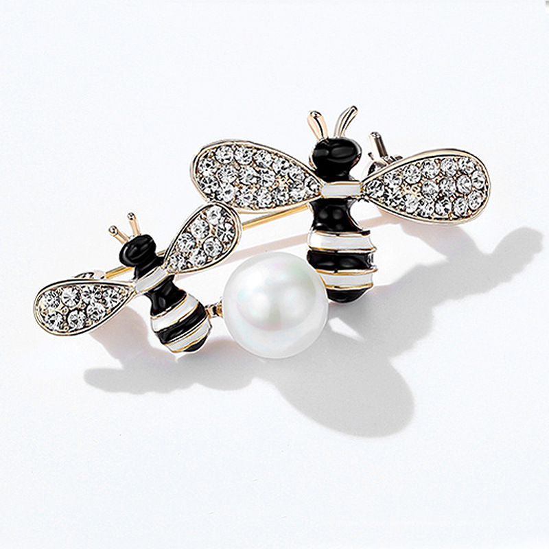 Black and white double bee brooch