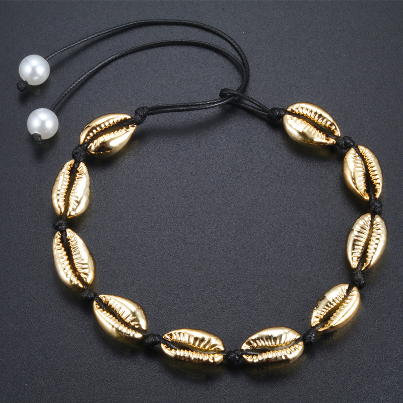 Gold shell with black thread