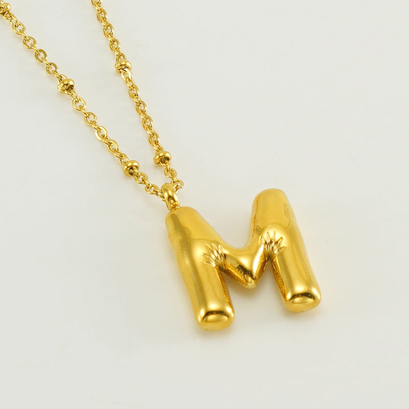 The gold letter M