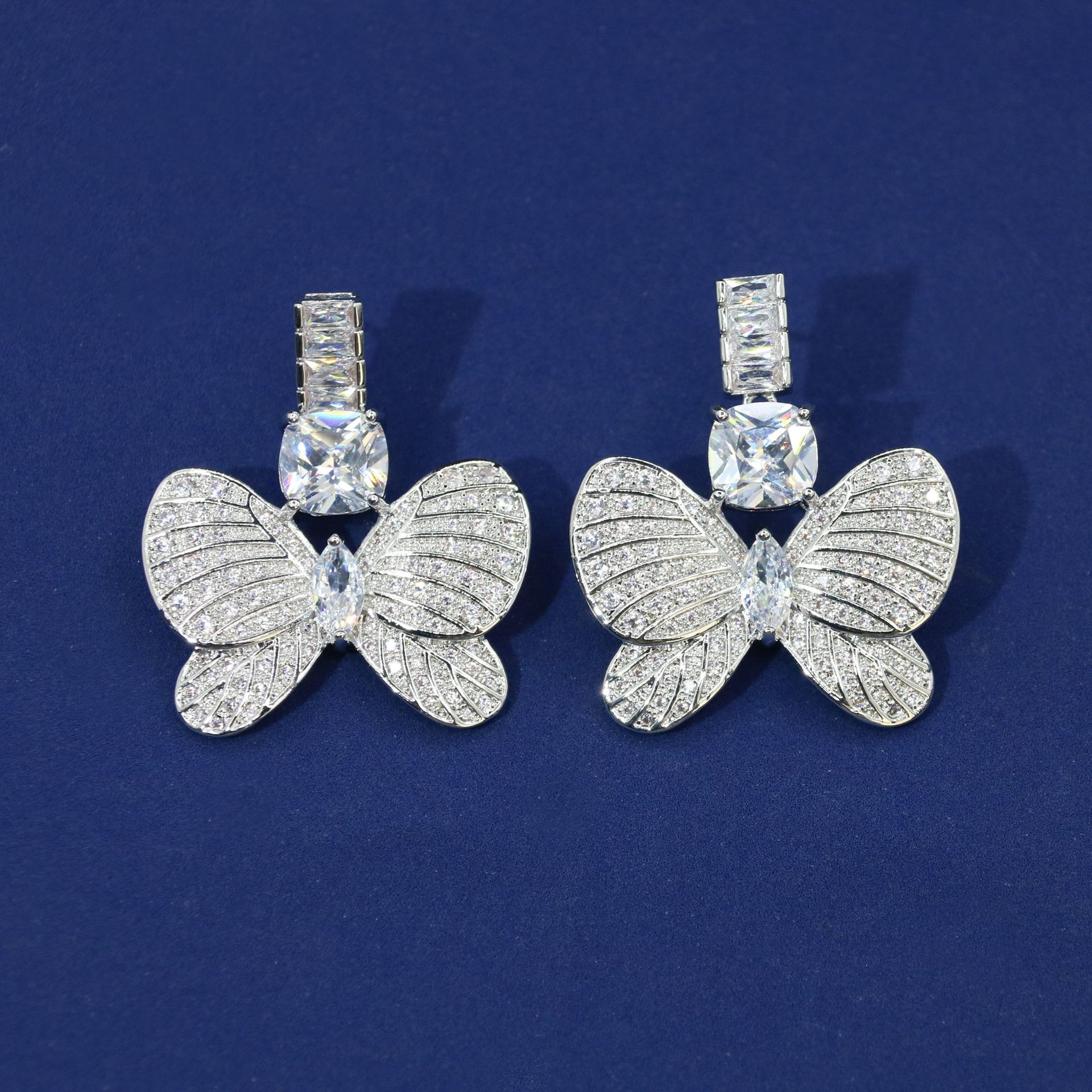 White zirconium earrings on white background