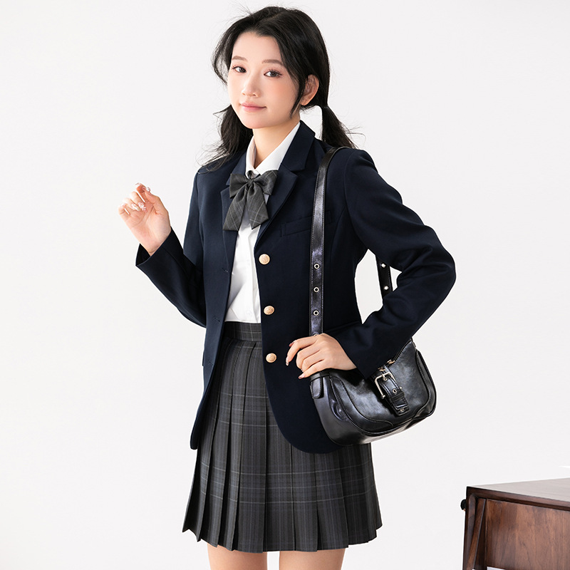 Navy blue suit   long sleeve shirt   charcoal plaid skirt   bow tie   badge