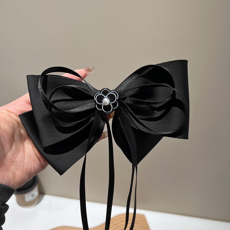 Black bow pearl streamer hair clip