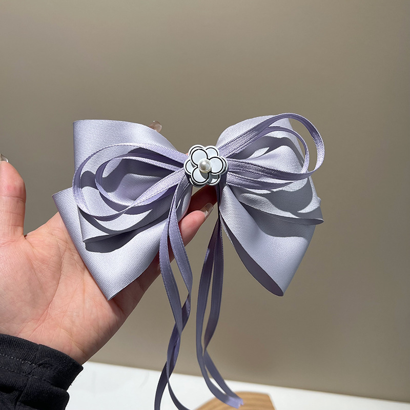 Purple bow pearl streamer hair clip