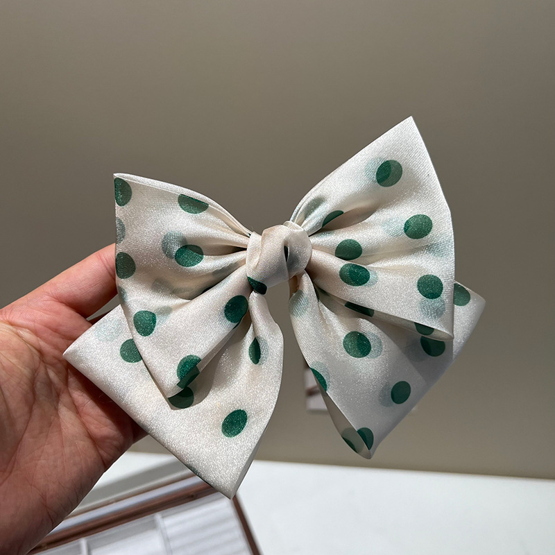 Green polka dot bow hair clip