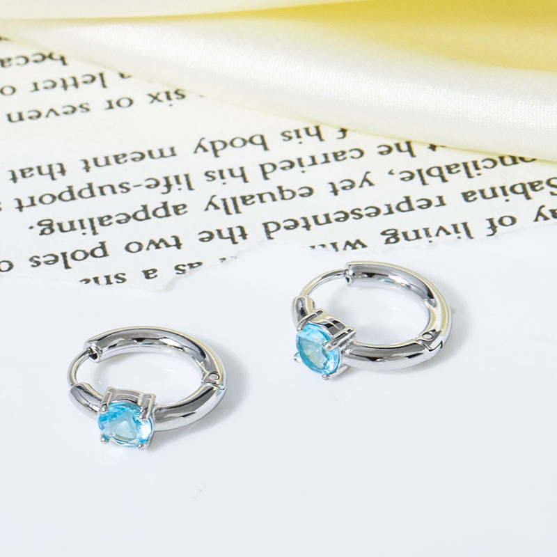 Silver with light blue zircon