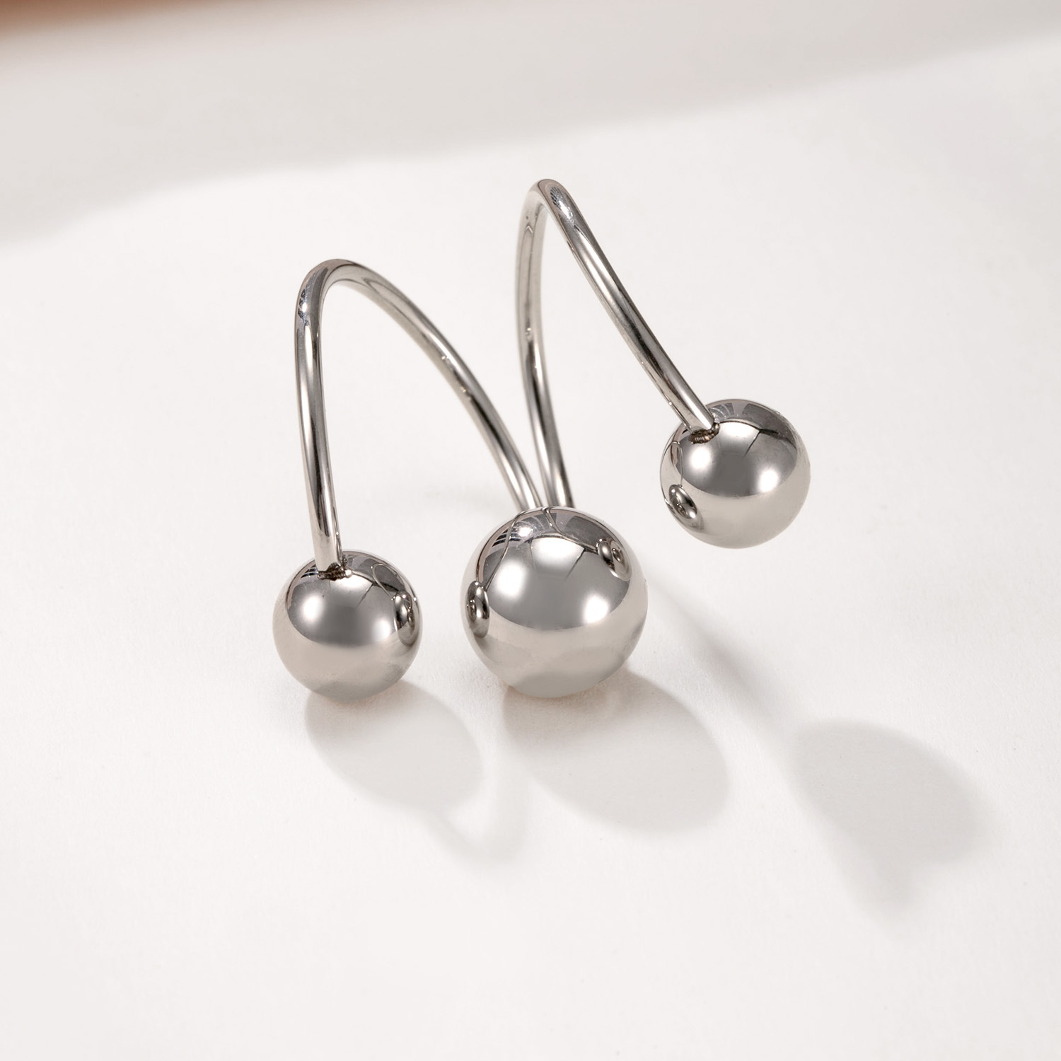 Three steel colored balls