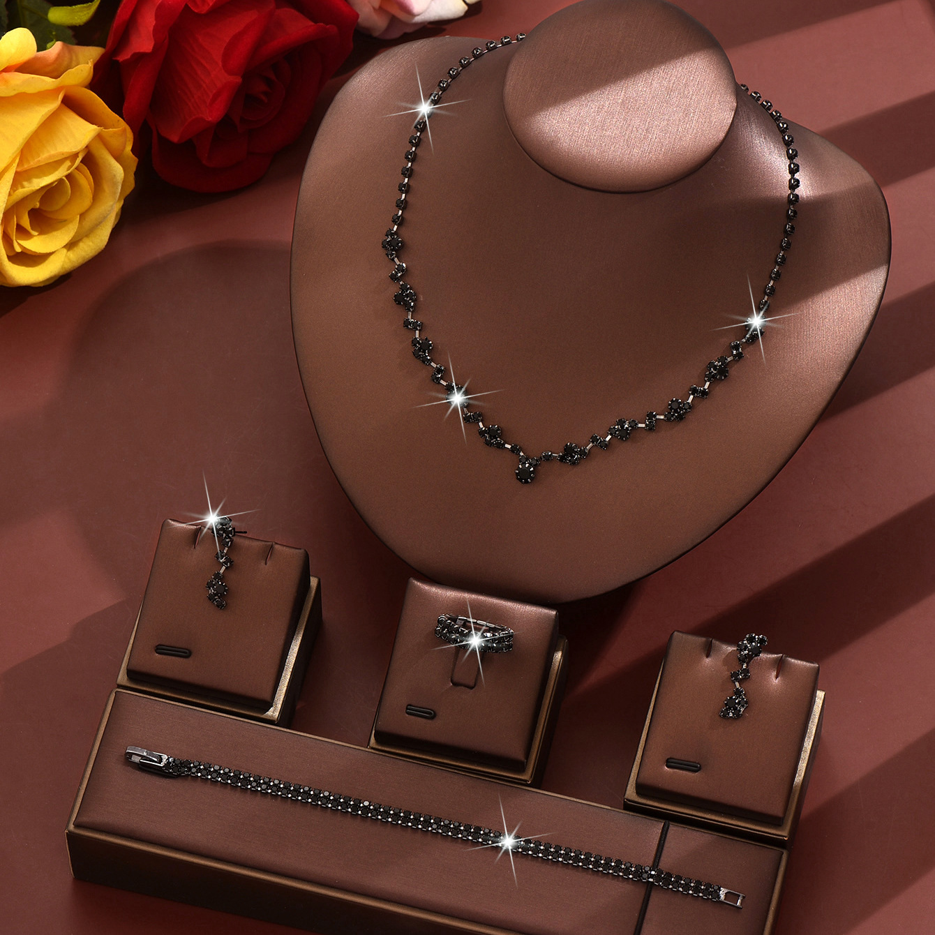 A black necklace earrings bracelet ring set