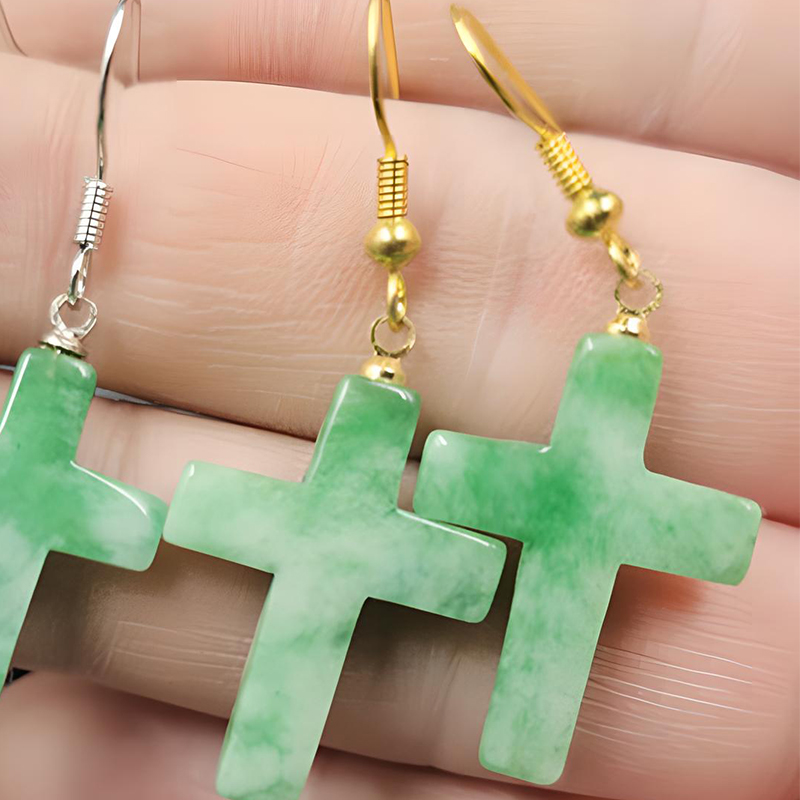 A pair of gold cross earrings