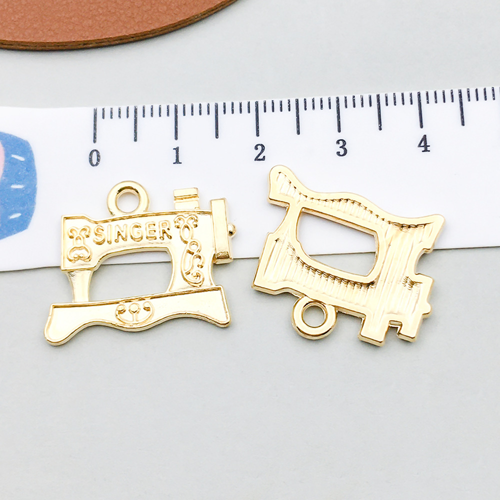 1 kc gold sewing machine 23*19mm-2g-20252
