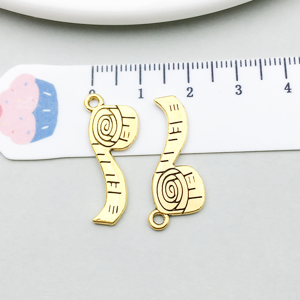 1 ancient gold measuring tape 11*27mm
