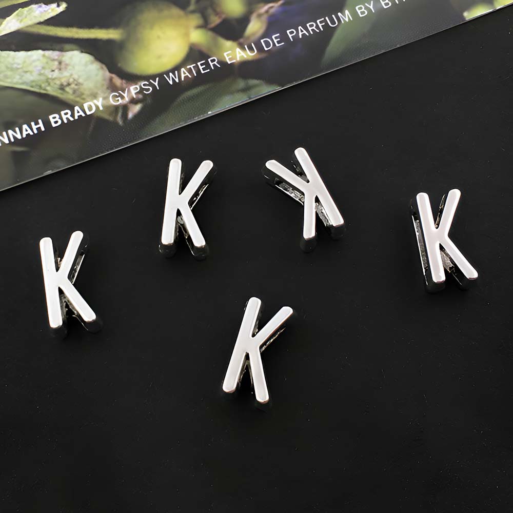 1 ancient silver perforated letter K-5x10mm-0.4g