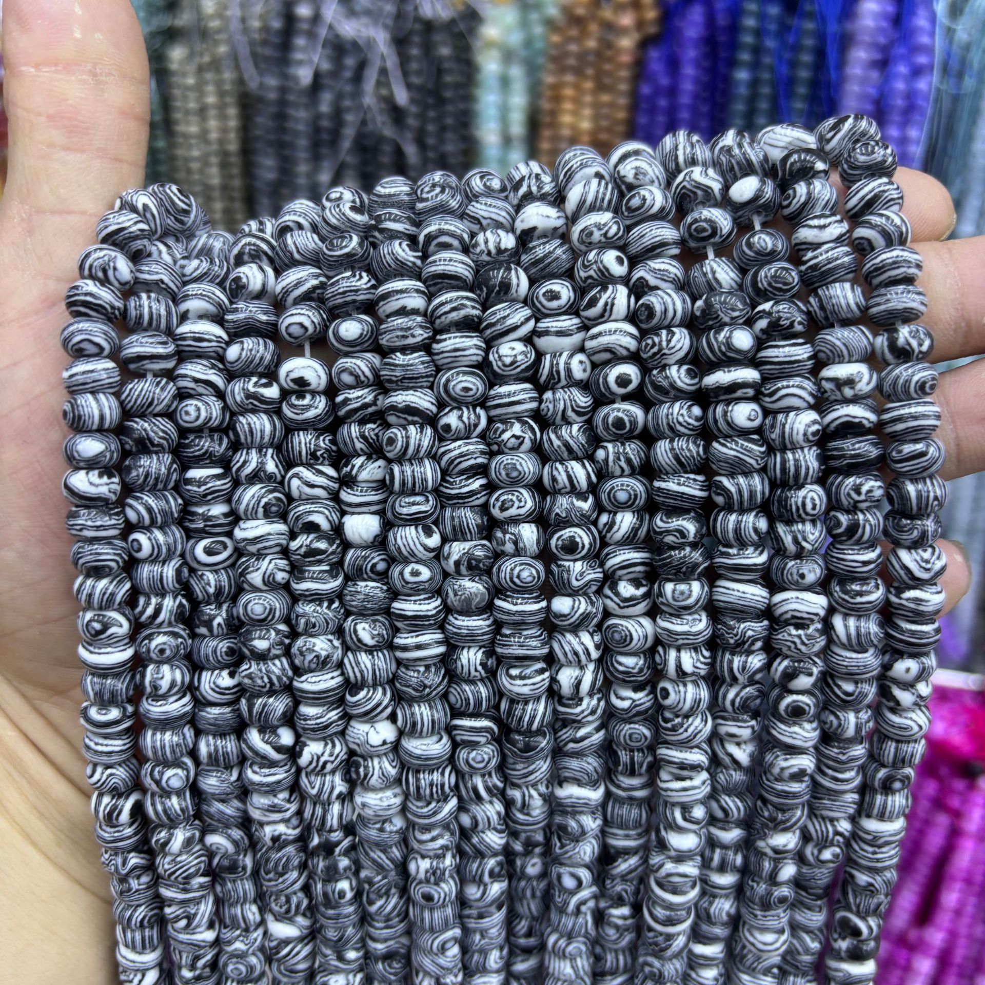 Synthetic black and white peacock abacus beads