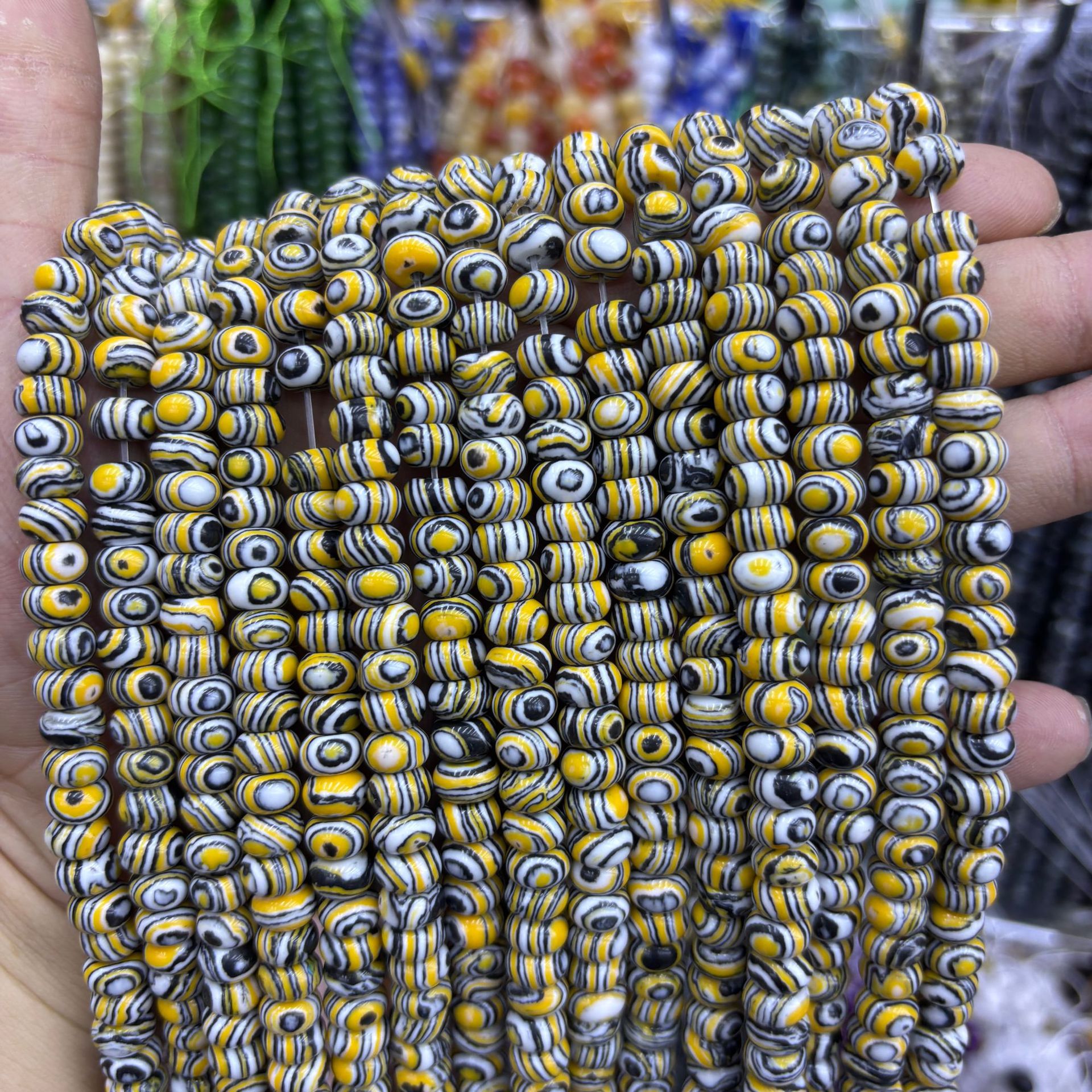 Synthetic brown peacock abacus beads