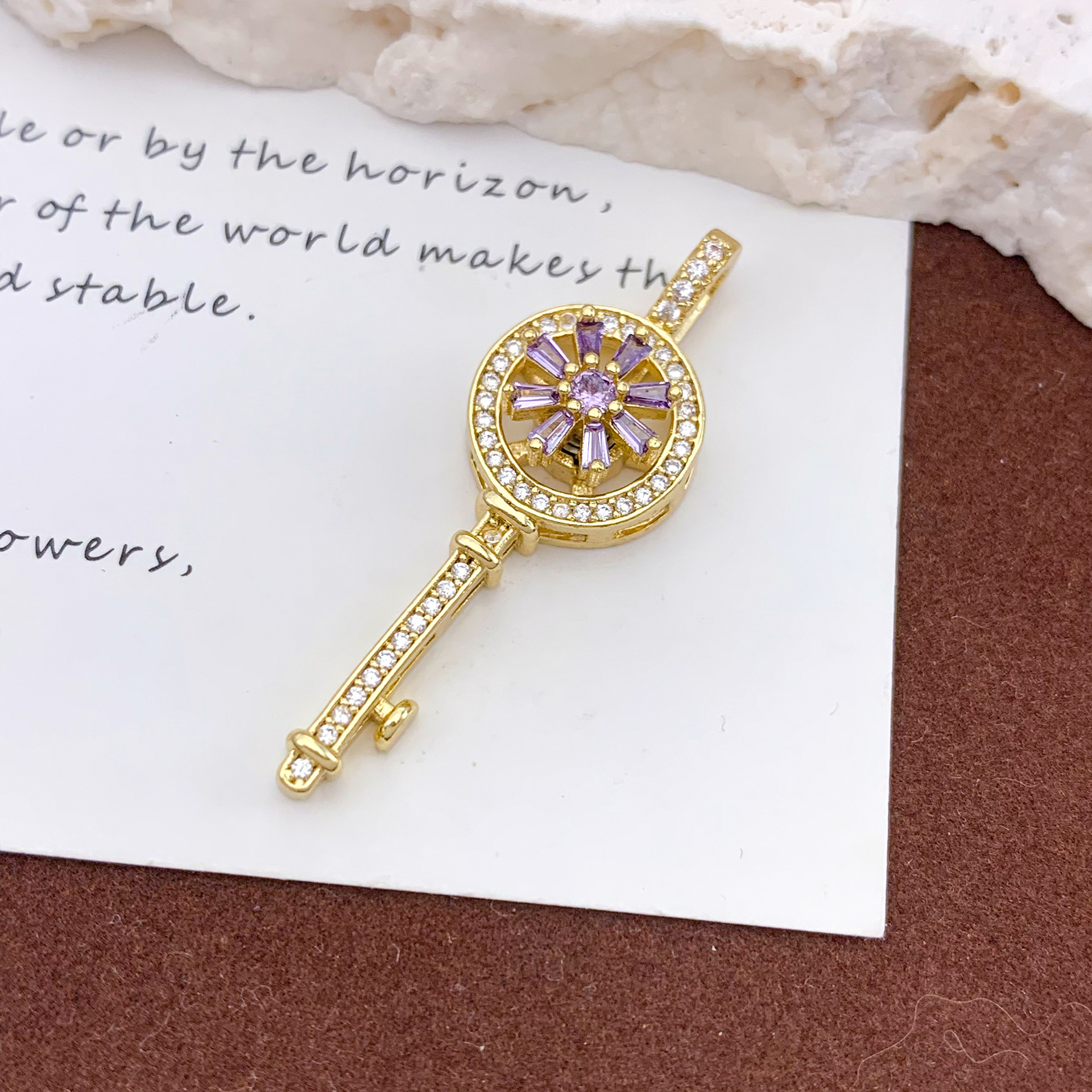 Xl1194 rotating purple key pendant gold