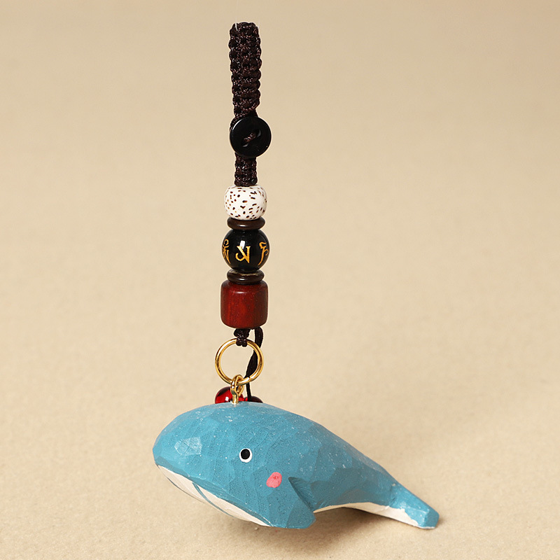 Wood carving of a whale-six-character mantra